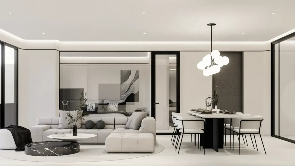 Bright living and dining area in a Phuket condo with off-white walls, soft grey sofa and glazed doors to a balcony